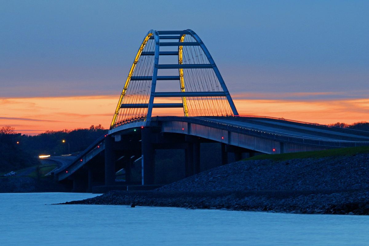 The arch of the Kentucky Lake Bridge against the sky at dusk