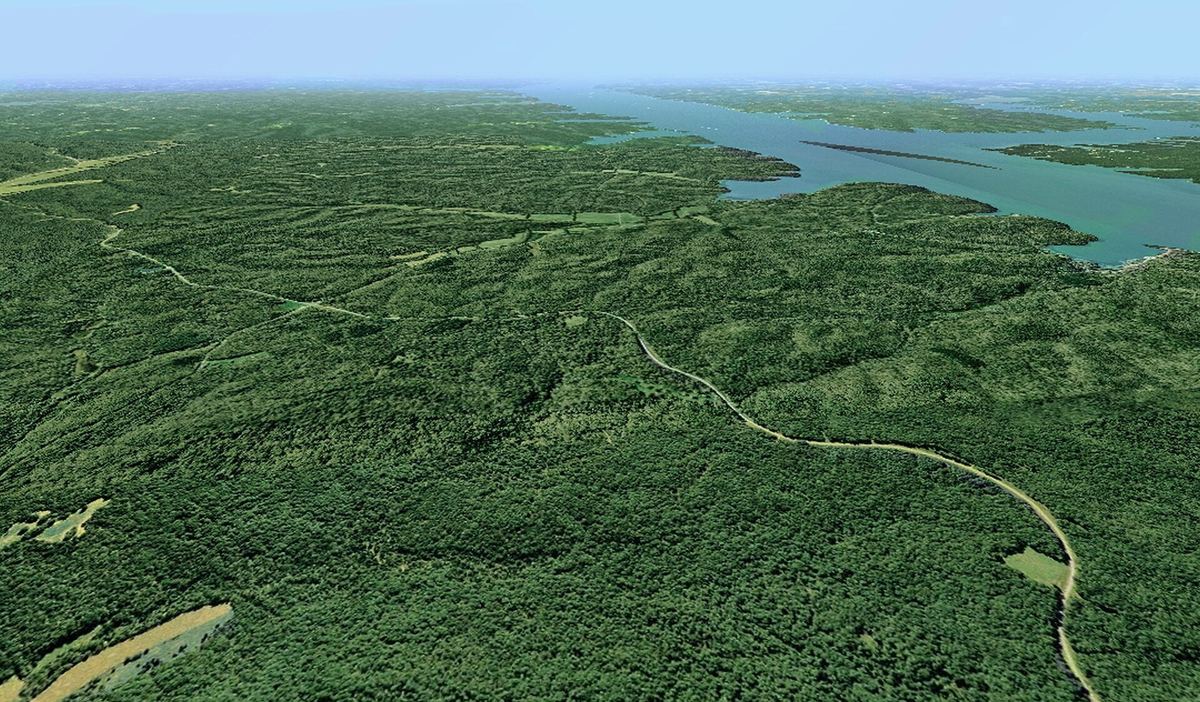 The Woodlands Trace road winding through the forest of Land Between the Lakes, seen from the air